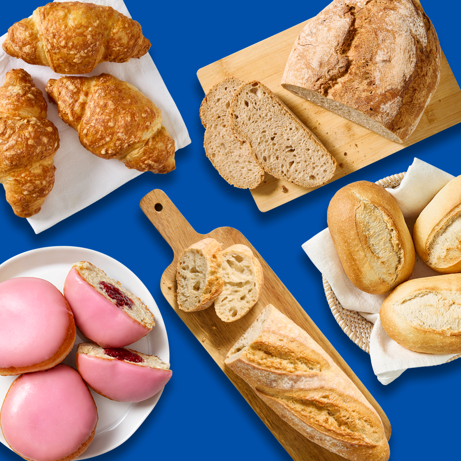 Ylhäältä kuvattu valikoima leivonnaisia ja leipiä sinisellä taustalla.